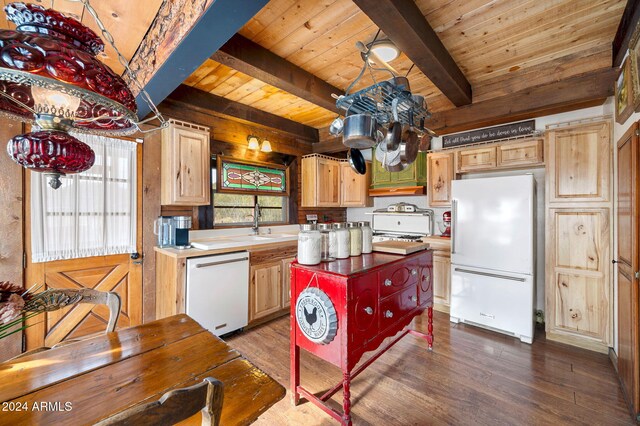 kitchen with hardwood / wood-style floors, a center island, white appliances, and a wealth of natural light