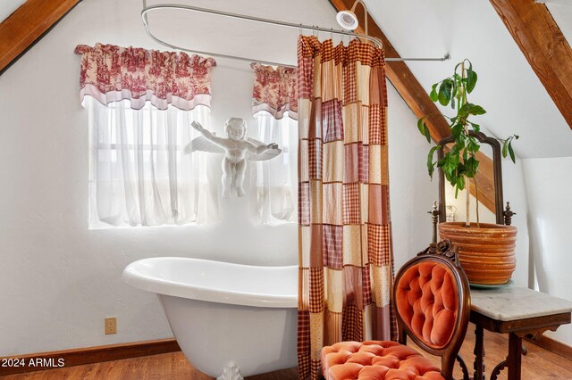 bathroom with hardwood / wood-style flooring and a bathtub