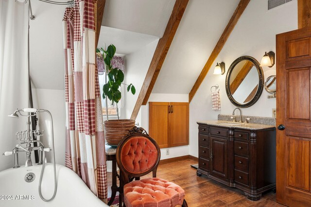 bathroom with hardwood / wood-style flooring, vaulted ceiling with beams, shower / bath combination with curtain, and vanity