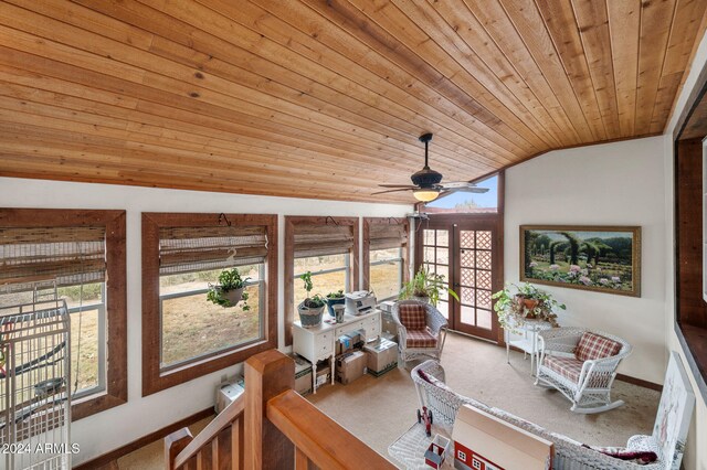 sunroom / solarium featuring lofted ceiling, ceiling fan, wooden ceiling, and french doors