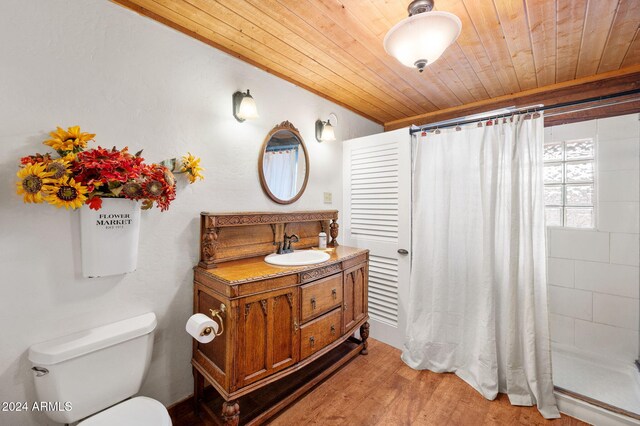 bathroom with a shower with curtain, hardwood / wood-style floors, toilet, vanity, and wood ceiling