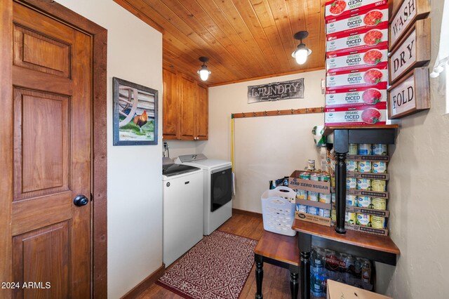 washroom featuring cabinets, hardwood / wood-style floors, wooden ceiling, and washing machine and clothes dryer