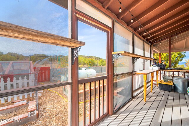 sunroom featuring a mountain view and vaulted ceiling