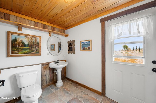 bathroom with toilet and wood ceiling