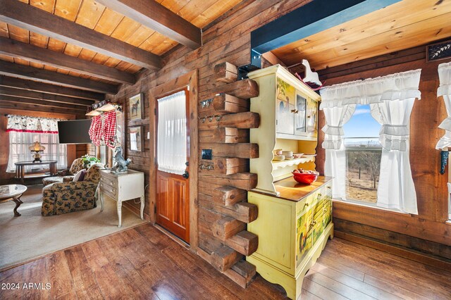 entrance foyer featuring beam ceiling, wood walls, hardwood / wood-style floors, and wood ceiling