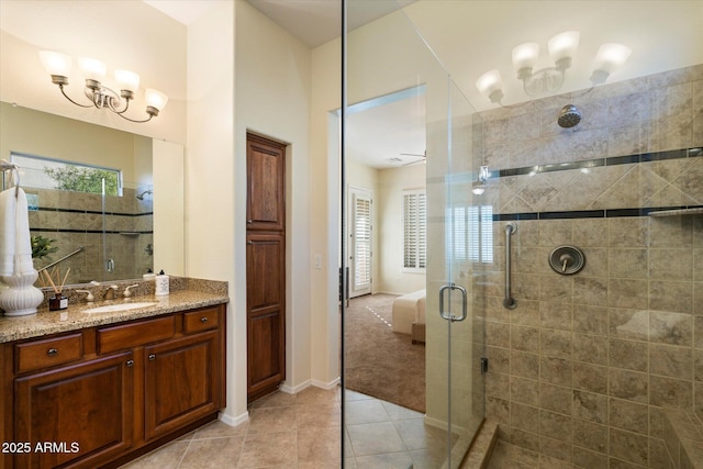 bathroom featuring walk in shower, vanity, and tile patterned flooring