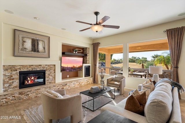 living room with ceiling fan, built in shelves, and a fireplace