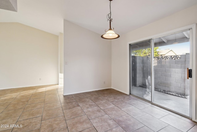 tiled empty room with vaulted ceiling