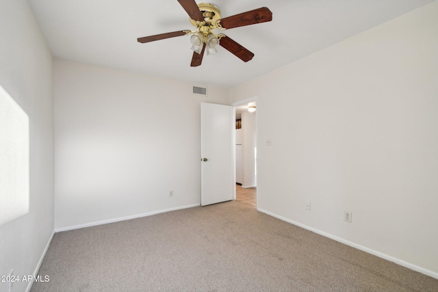 unfurnished room featuring light colored carpet and ceiling fan