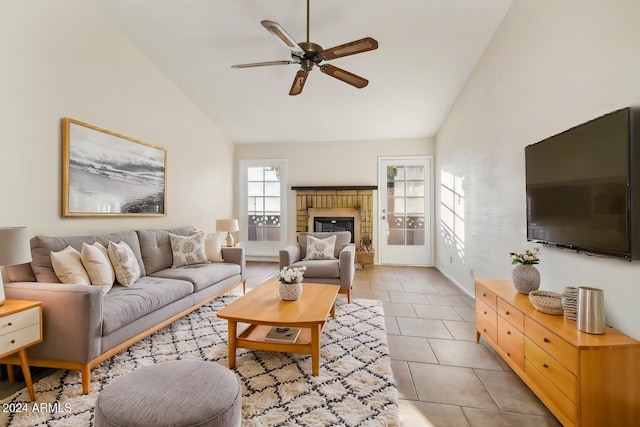 tiled living room with a fireplace, high vaulted ceiling, and ceiling fan