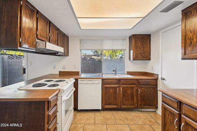 kitchen featuring sink, white appliances, and light tile patterned flooring