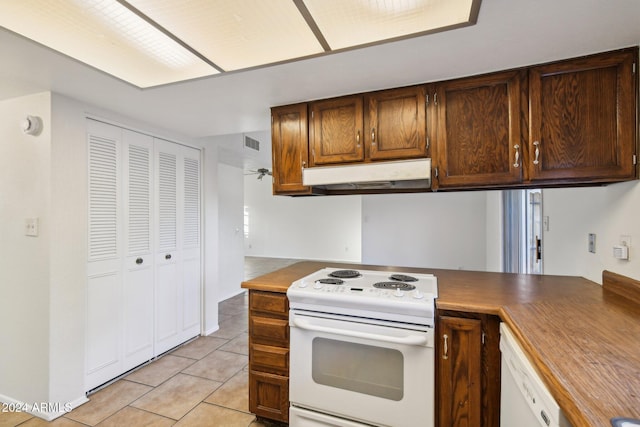 kitchen with white appliances and light tile patterned floors