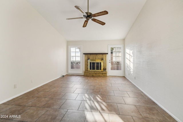 unfurnished living room featuring ceiling fan, tile patterned floors, a fireplace, and lofted ceiling