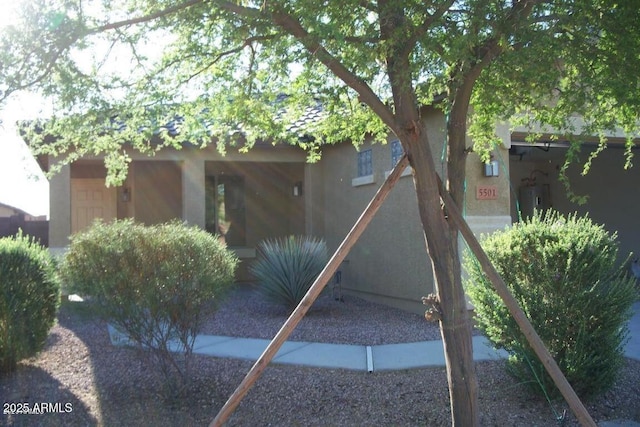 rear view of property with stucco siding