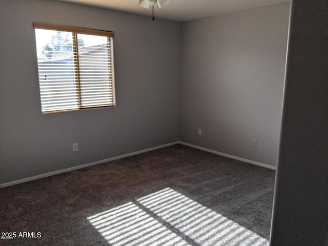 carpeted spare room with baseboards