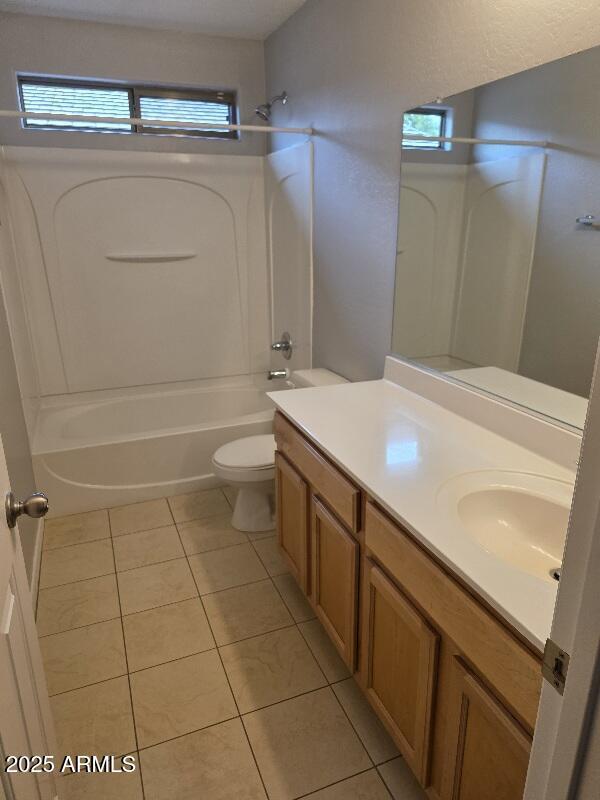 bathroom featuring toilet, shower / tub combination, plenty of natural light, tile patterned flooring, and vanity