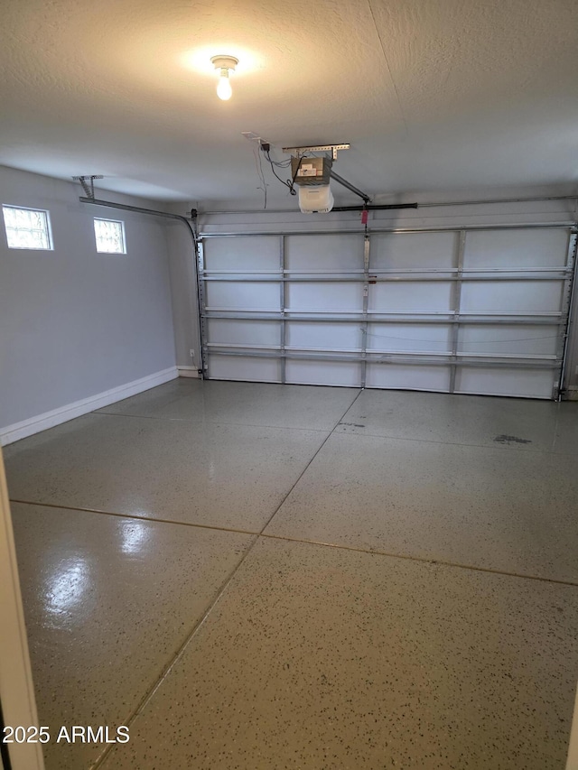 garage featuring baseboards and a garage door opener