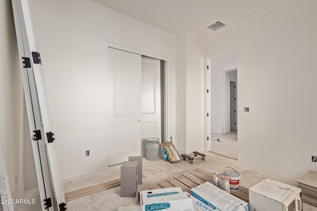 bedroom with a closet and baseboards