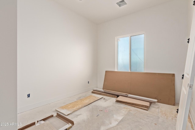 spare room with baseboards