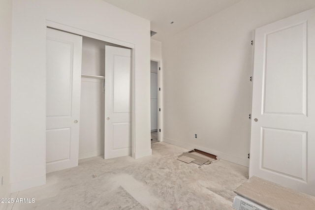 unfurnished bedroom with a closet and baseboards