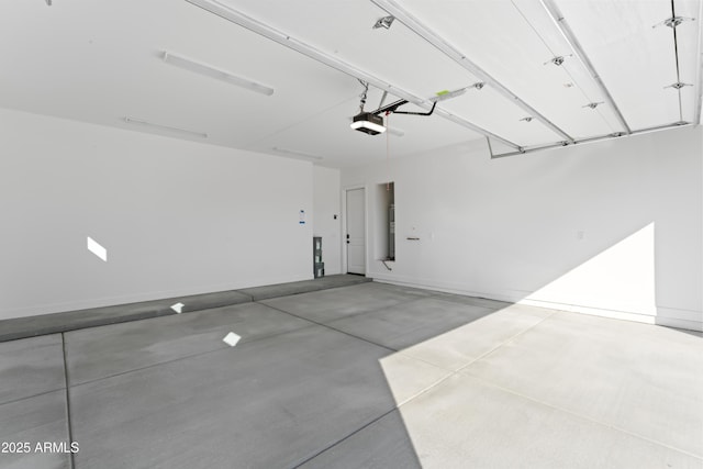 garage with baseboards and a garage door opener