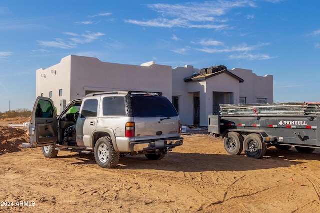 pueblo-style house featuring stucco siding