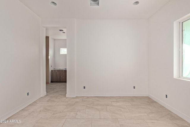 unfurnished room with baseboards