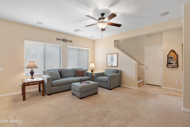 carpeted living room with ceiling fan