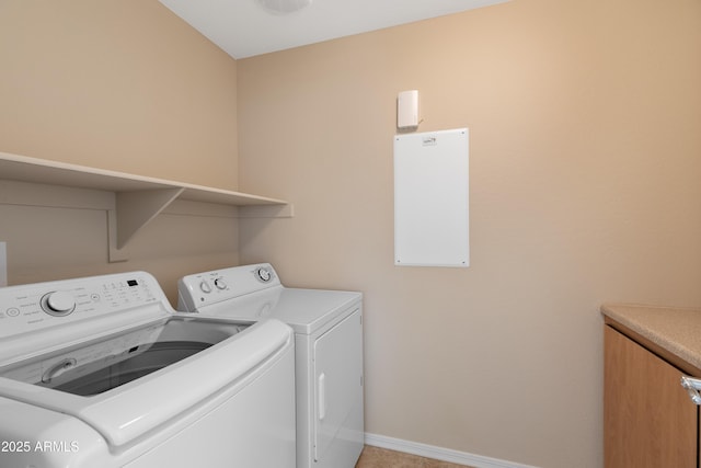 laundry area with cabinets and washer and clothes dryer