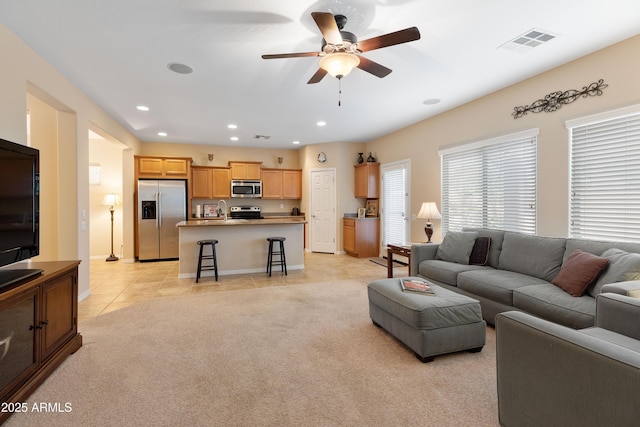 living room with light tile patterned floors and ceiling fan