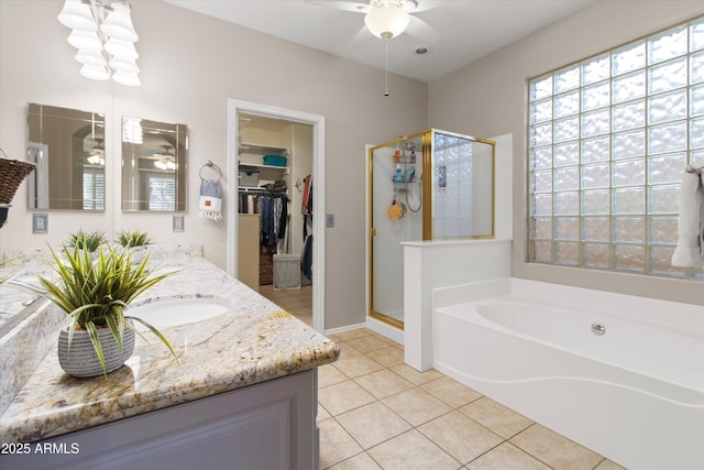 bathroom featuring vanity, tile patterned floors, shower with separate bathtub, and ceiling fan