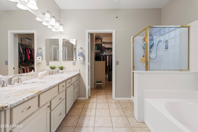 bathroom with tile patterned floors, shower with separate bathtub, and vanity