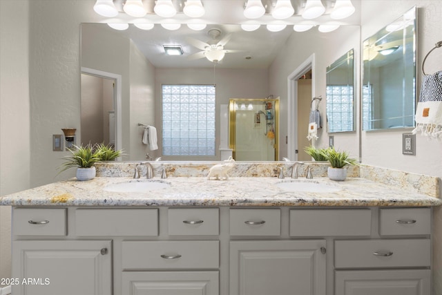 bathroom featuring vanity, a shower with shower door, and ceiling fan