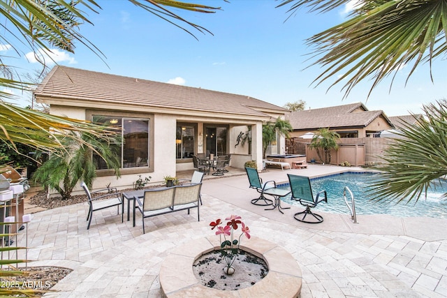 view of pool featuring a jacuzzi, a patio area, and an outdoor fire pit