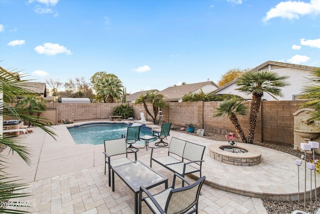 view of swimming pool featuring a patio area and a fire pit