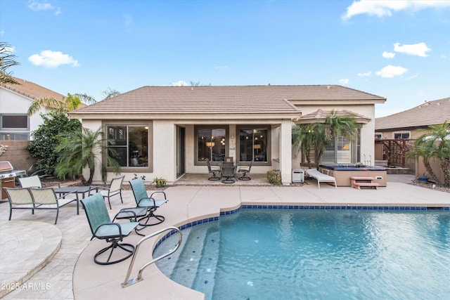 view of swimming pool featuring a grill, a jacuzzi, and a patio