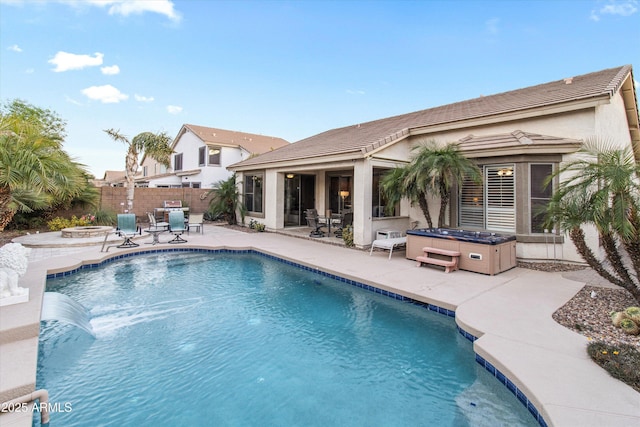 view of swimming pool with an outdoor fire pit, a hot tub, and a patio area