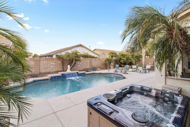 view of pool with pool water feature, an outdoor hot tub, and a patio