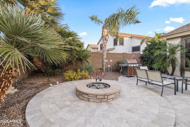 view of patio featuring a grill and a fire pit