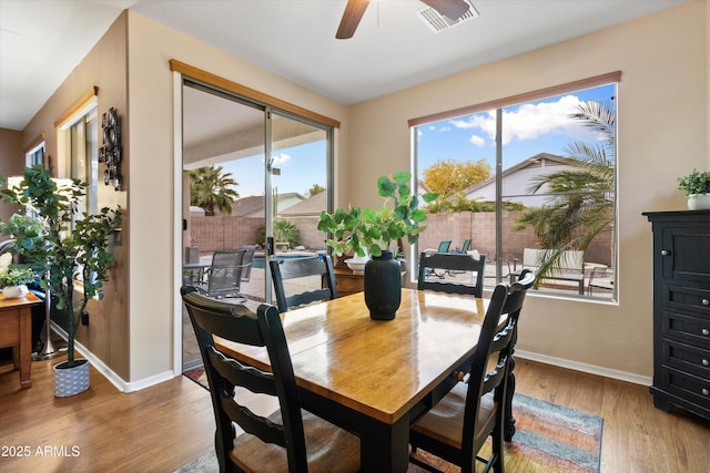 dining area with ceiling fan and light wood-type flooring