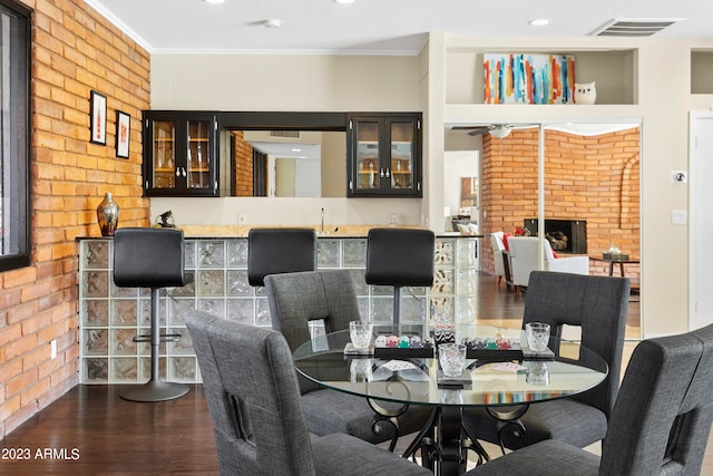 dining room with brick wall and ornamental molding