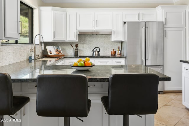 kitchen with a breakfast bar area, tasteful backsplash, and sink