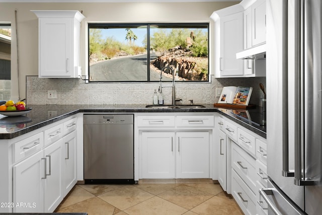 kitchen with white cabinetry, backsplash, light tile flooring, sink, and stainless steel appliances