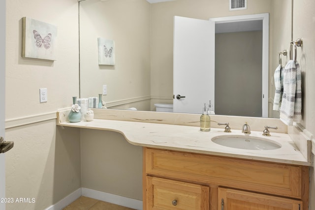 bathroom with tile floors, toilet, and vanity