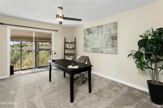 home office featuring light carpet and ceiling fan