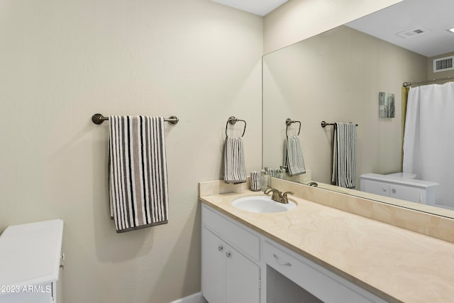 bathroom featuring toilet and oversized vanity