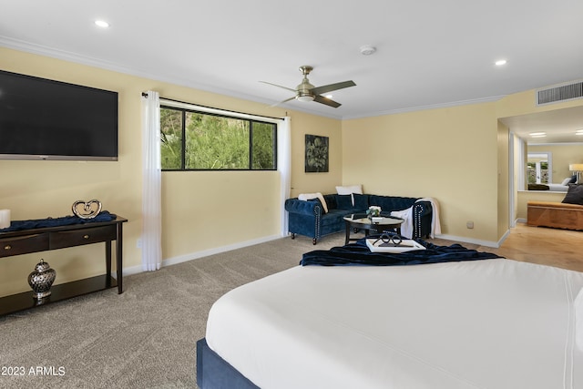 bedroom featuring light carpet, ornamental molding, and ceiling fan