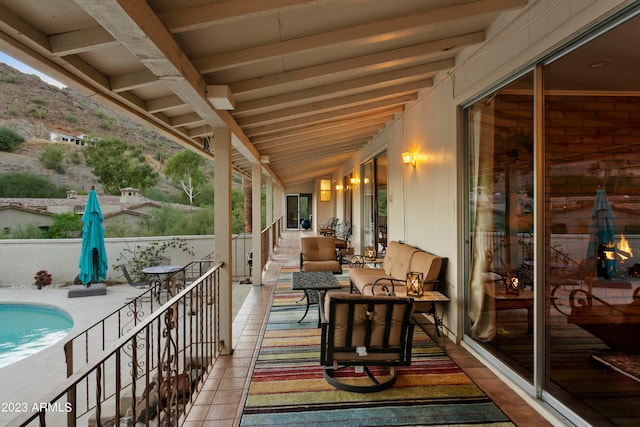 exterior space featuring an outdoor hangout area and a fenced in pool