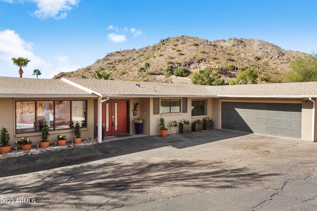 single story home with a mountain view and a garage