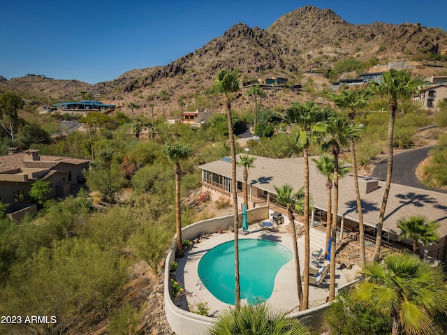 view of swimming pool featuring a patio area and a mountain view